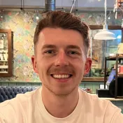 Mark, smiling, in a white t-shirt